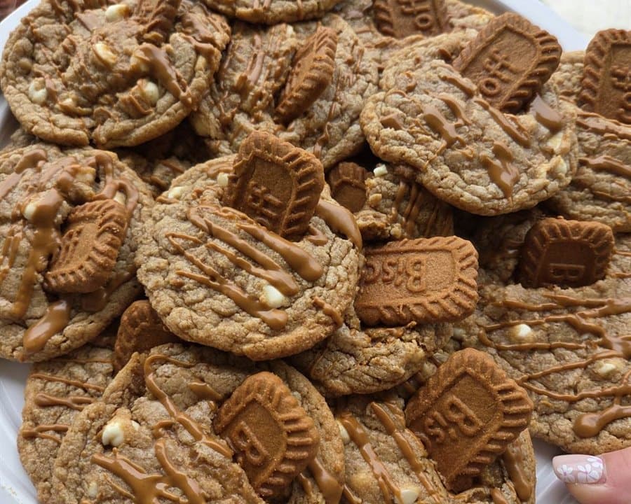 A platter of Biscoff cookies topped with Biscoff biscuit pieces and cookie butter drizzle.